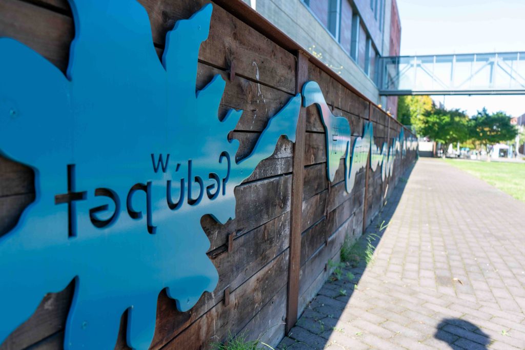 A metal art piece depicting waterways, with the Lushootseed name for Tahoma, also known as Mount Rainier.
